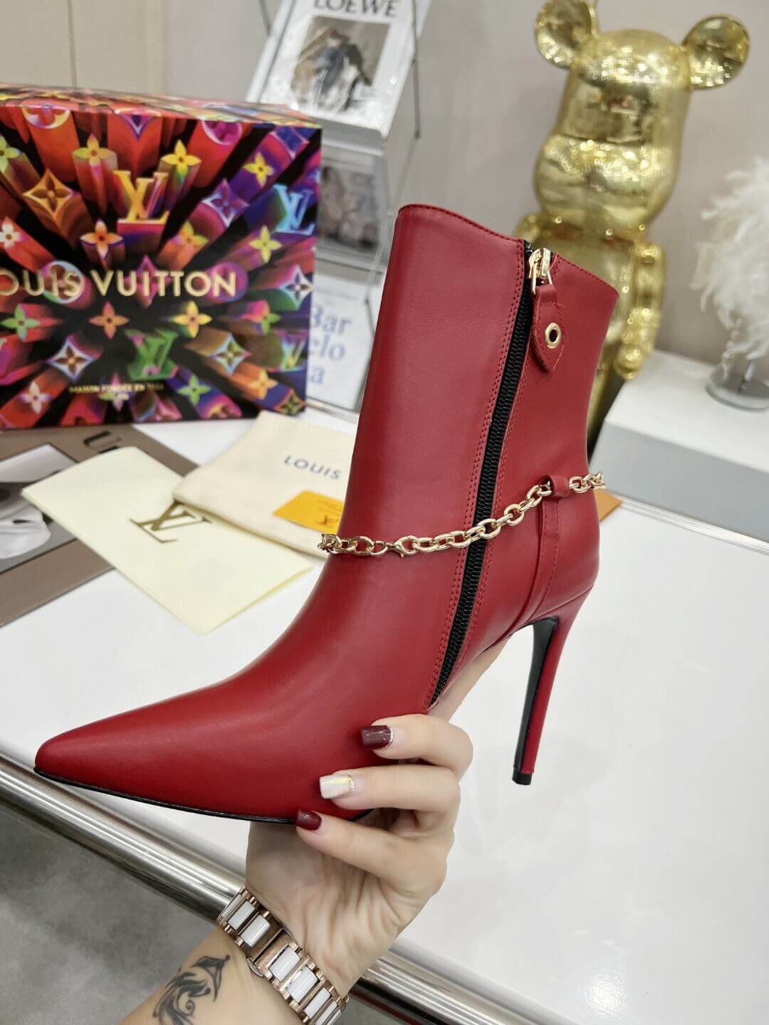 a pair of Red Louis Vuitton Mansion Chain Ankle Boots