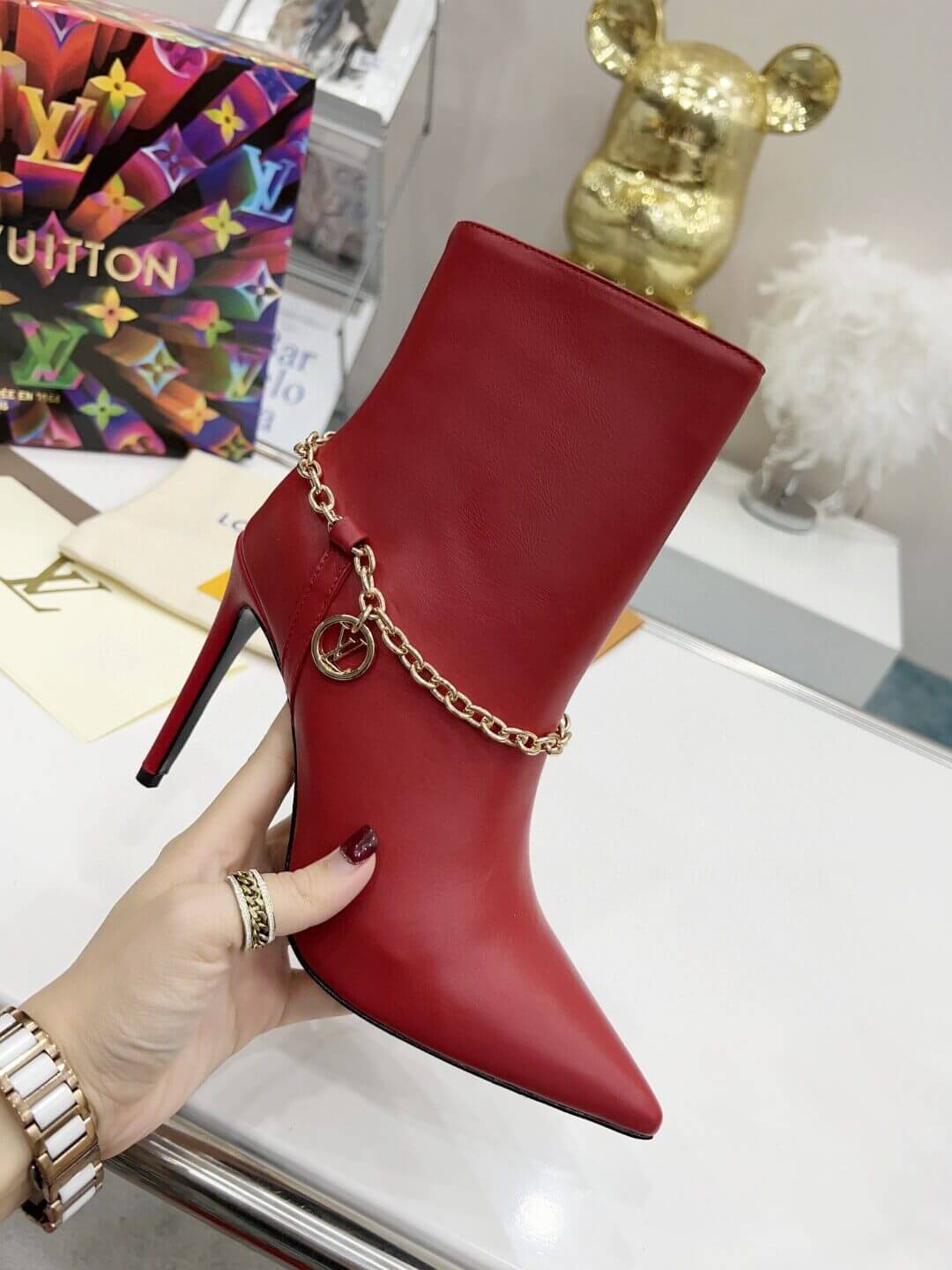 a pair of Red Louis Vuitton Mansion Chain Ankle Boots