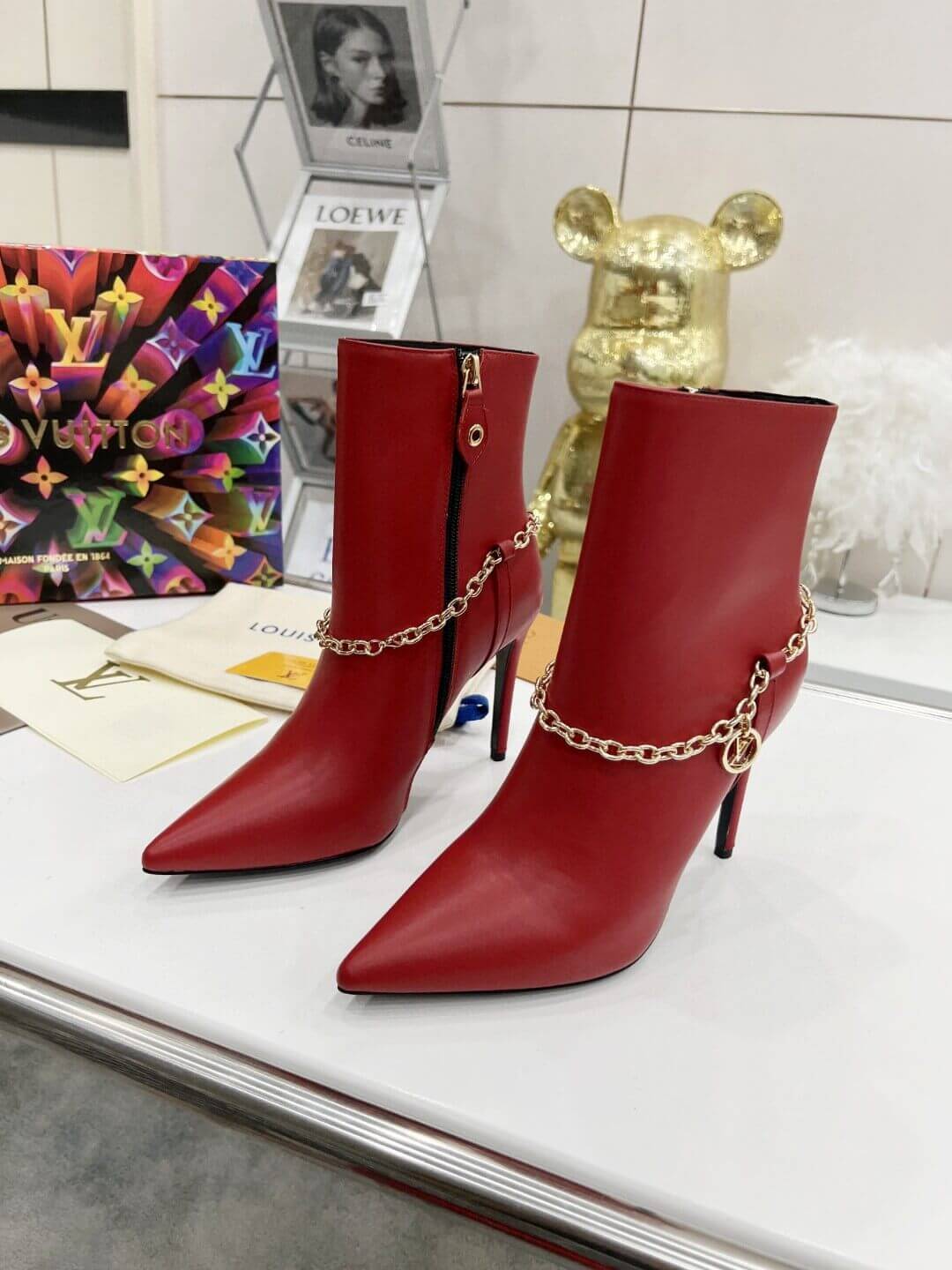 a pair of Red Louis Vuitton Mansion Chain Ankle Boots