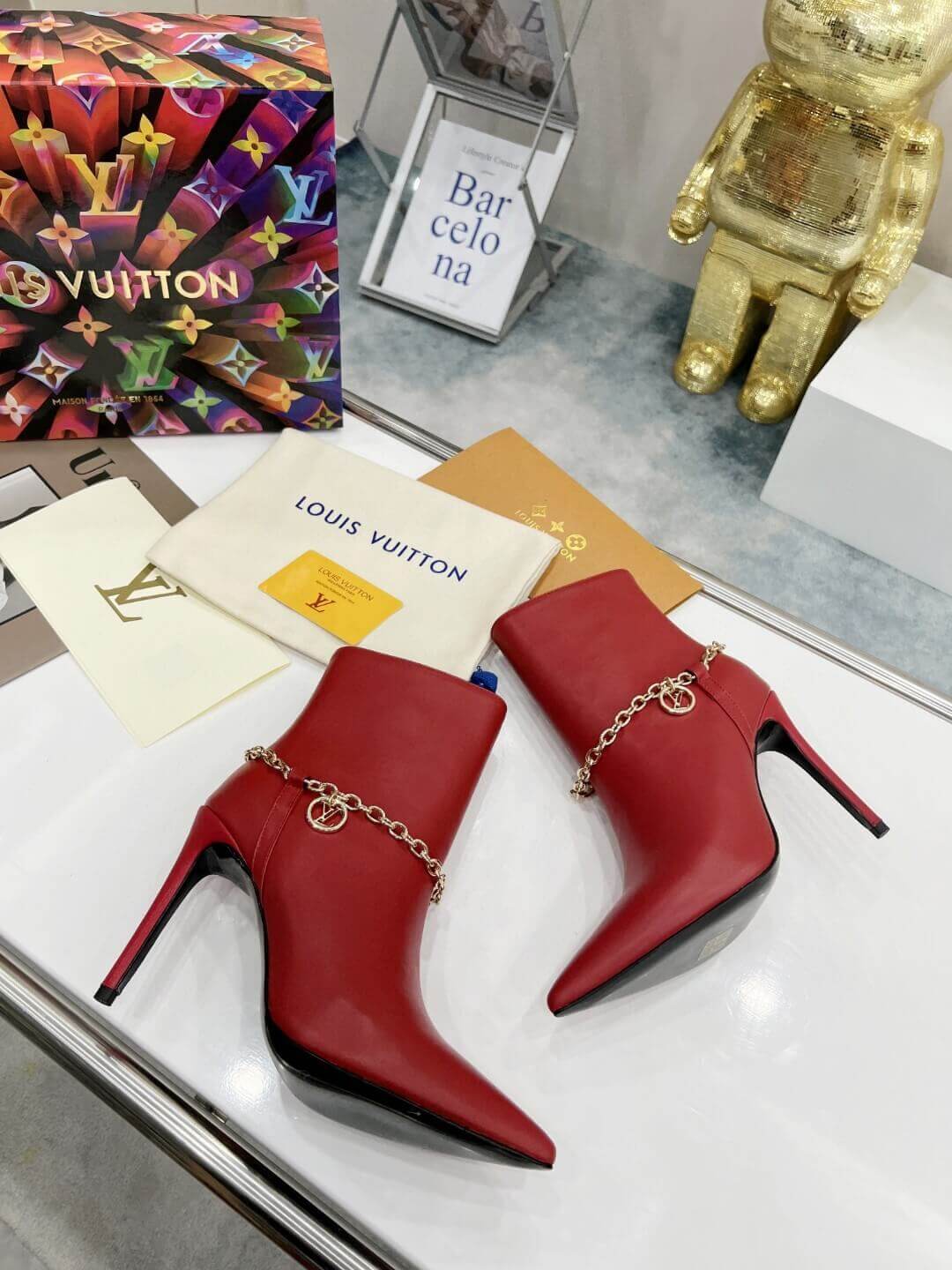 a pair of Red Louis Vuitton Mansion Chain Ankle Boots