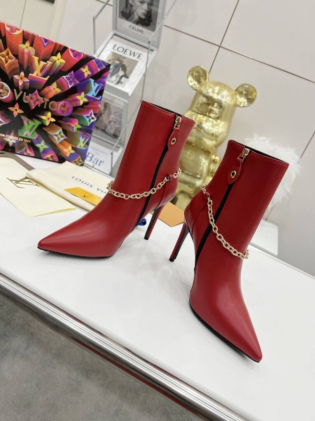 a pair of Red Louis Vuitton Mansion Chain Ankle Boots