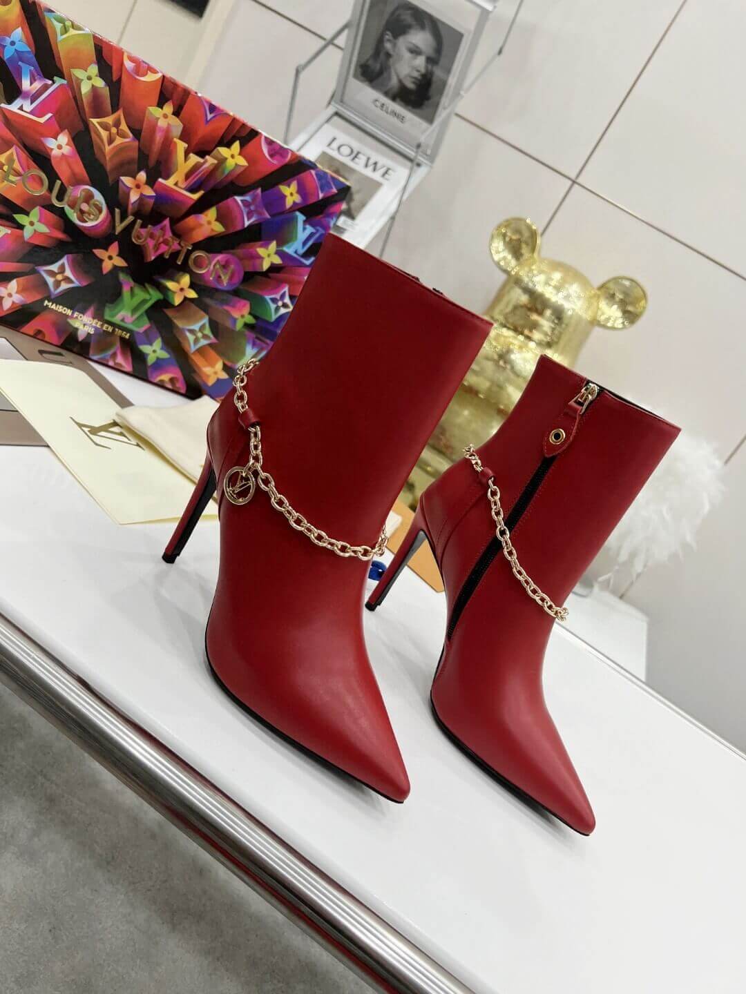 a pair of Red Louis Vuitton Mansion Chain Ankle Boots