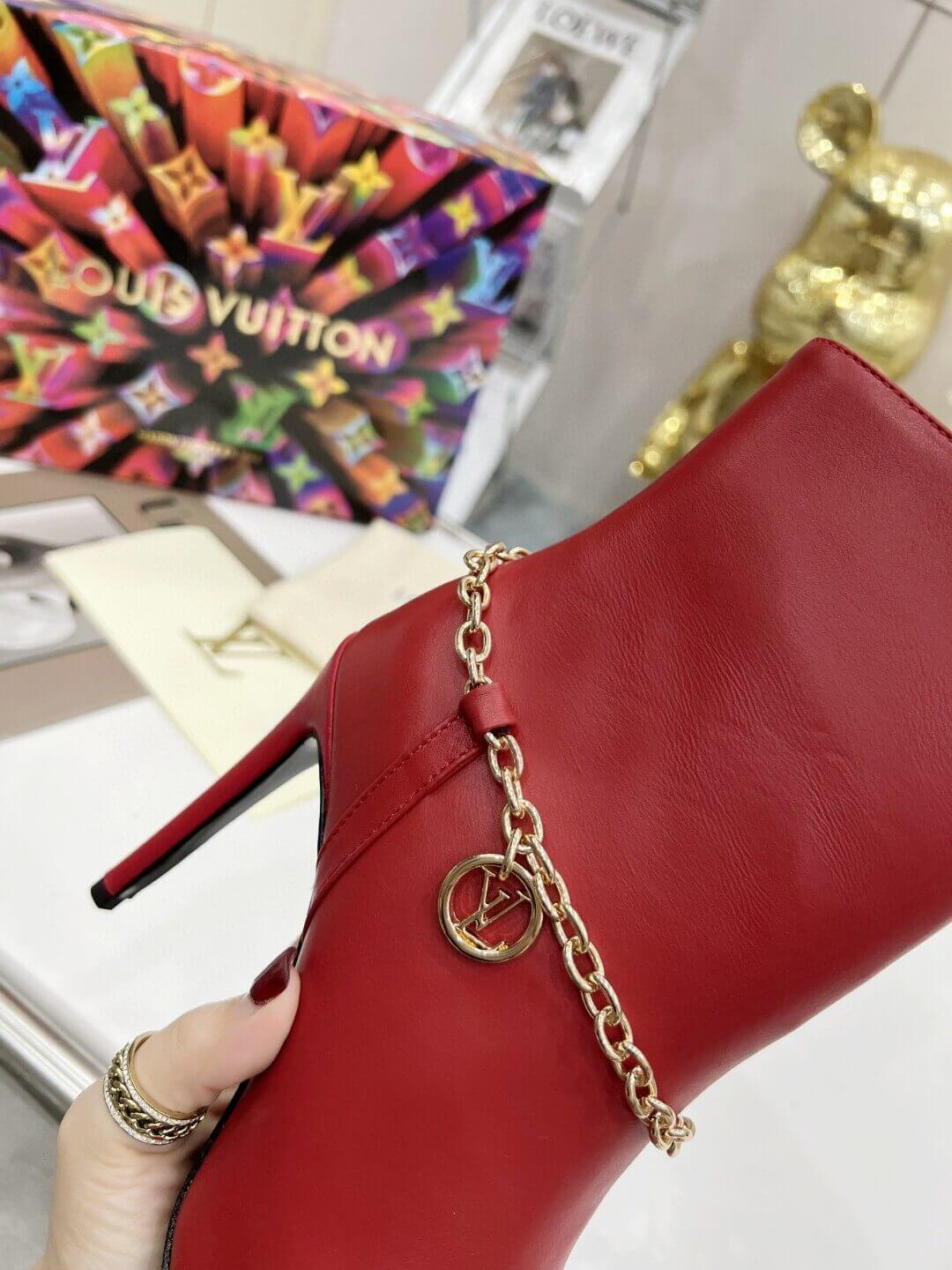 a pair of Red Louis Vuitton Mansion Chain Ankle Boots