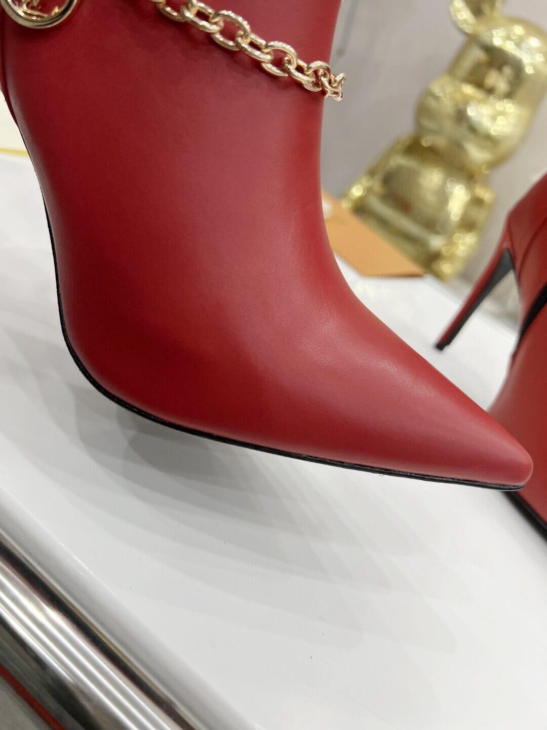 a pair of Red Louis Vuitton Mansion Chain Ankle Boots