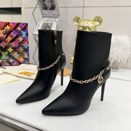 a pair of Louis Vuitton Calfskin Mansion Chain Ankle Boots (Black)
