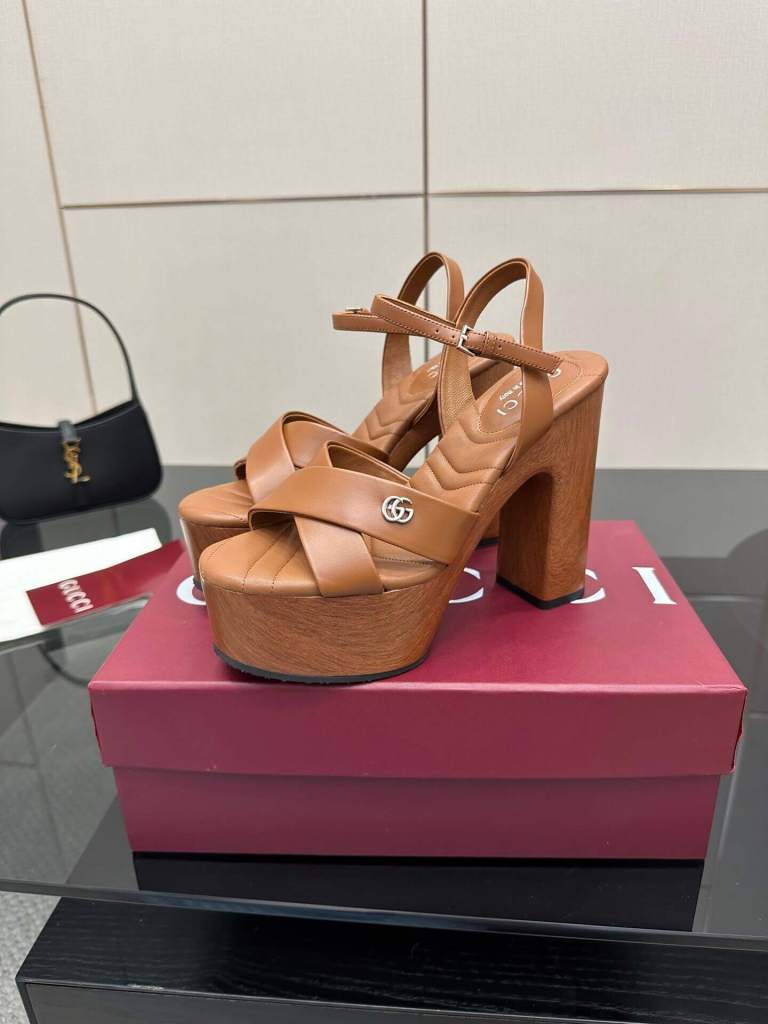 a pair of Gucci Platform Sandals with Interlocking G Detail (Brown/Wood) on a box