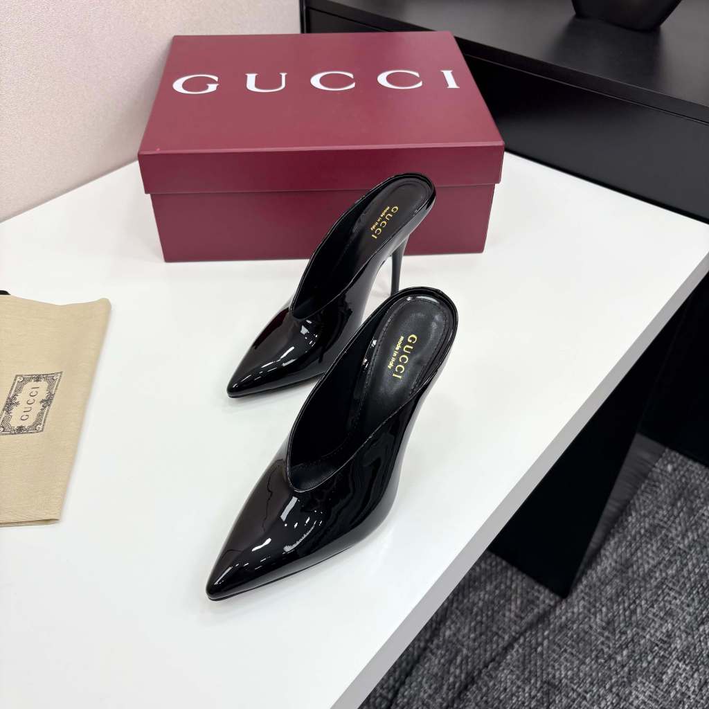 a Gucci Women's Black Shiny Patent Leather Pointed-Toe Stiletto Pumps on a red box
