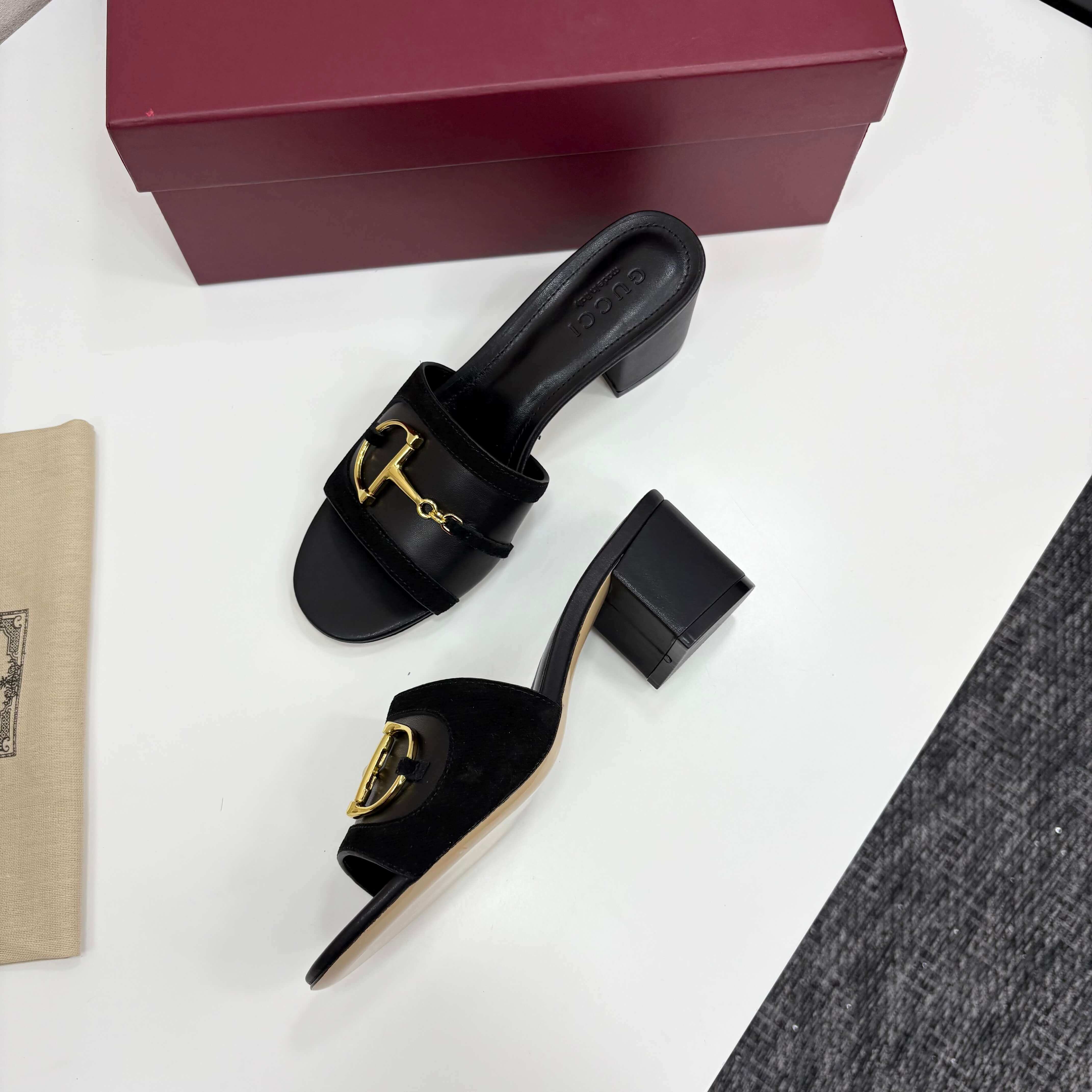 a pair of Gucci Women's Black Suede Block Heel Slide Sandals with Horsebit and GG Monogram Canvas