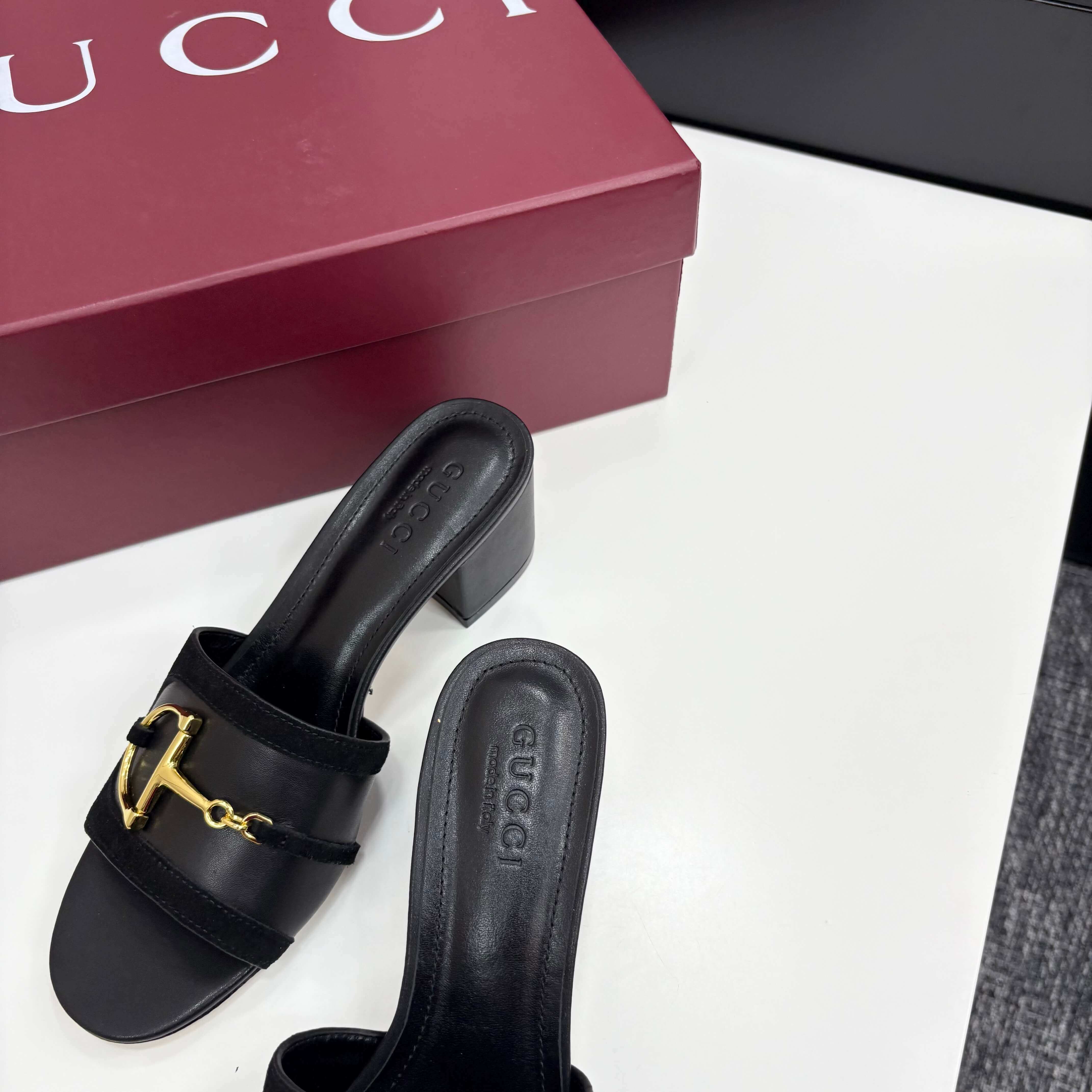 a pair of Gucci Women's Black Suede Block Heel Slide Sandals with Horsebit and GG Monogram Canvas