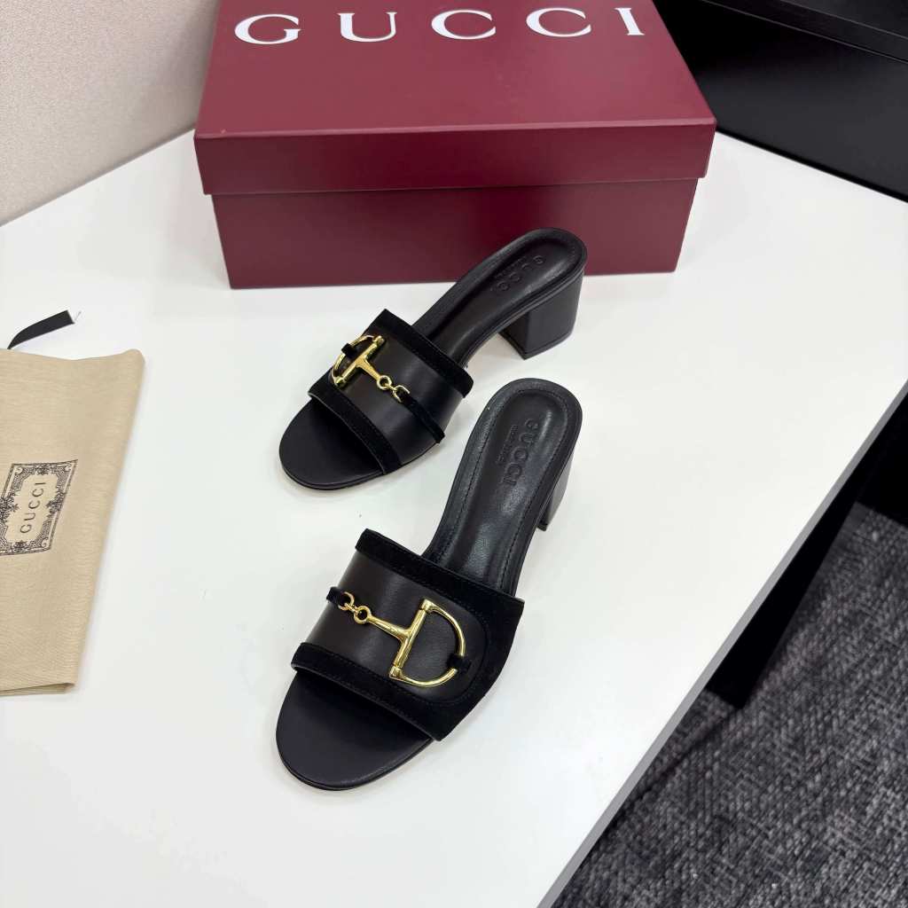 a pair of Gucci Women's Black Suede Block Heel Slide Sandals with Horsebit and GG Monogram Canvas