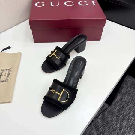 a pair of Gucci Women's Black Suede Block Heel Slide Sandals with Horsebit and GG Monogram Canvas
