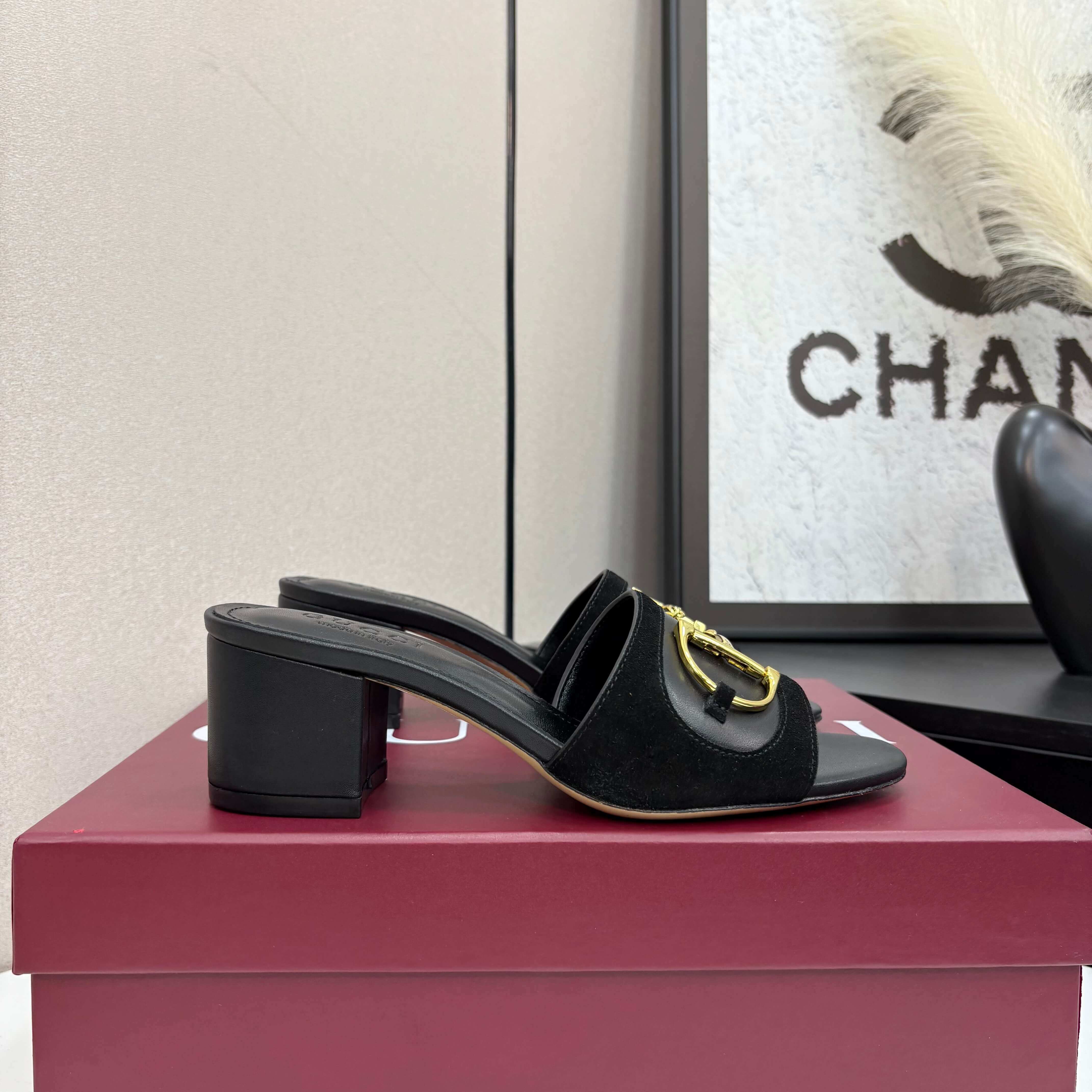 a pair of Gucci Women's Black Suede Block Heel Slide Sandals with Horsebit and GG Monogram Canvas