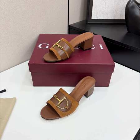 a pair of Gucci Women's Brown Suede Block Heel Slide Sandals with Horsebit and GG Monogram Canvas