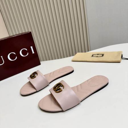 a pair of Gucci Women's Double G slide sandal - Pink on a white table