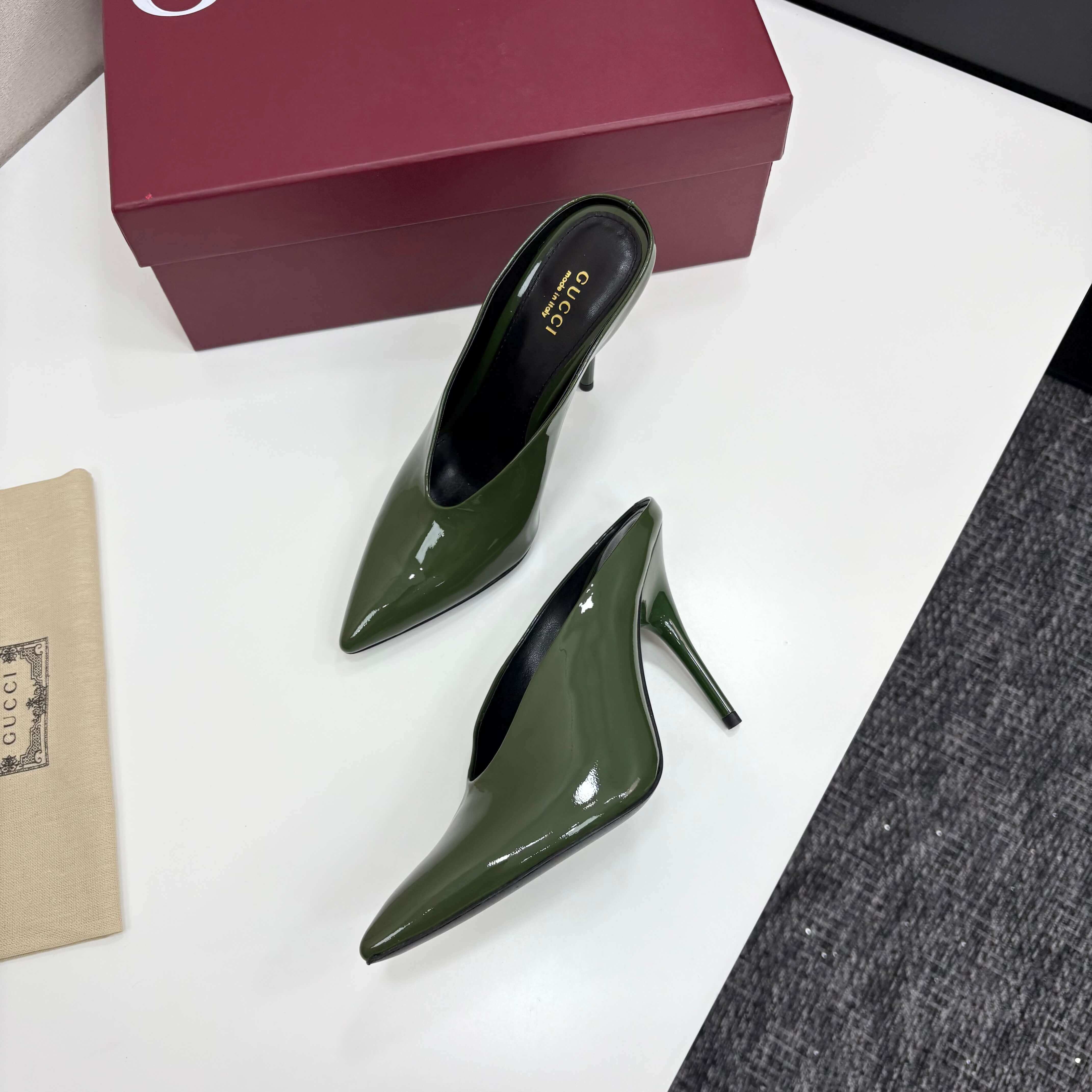 a pair of Gucci Women's Green Shiny Patent Leather Slingback Pumps with Pointed Toe and Thin Hee