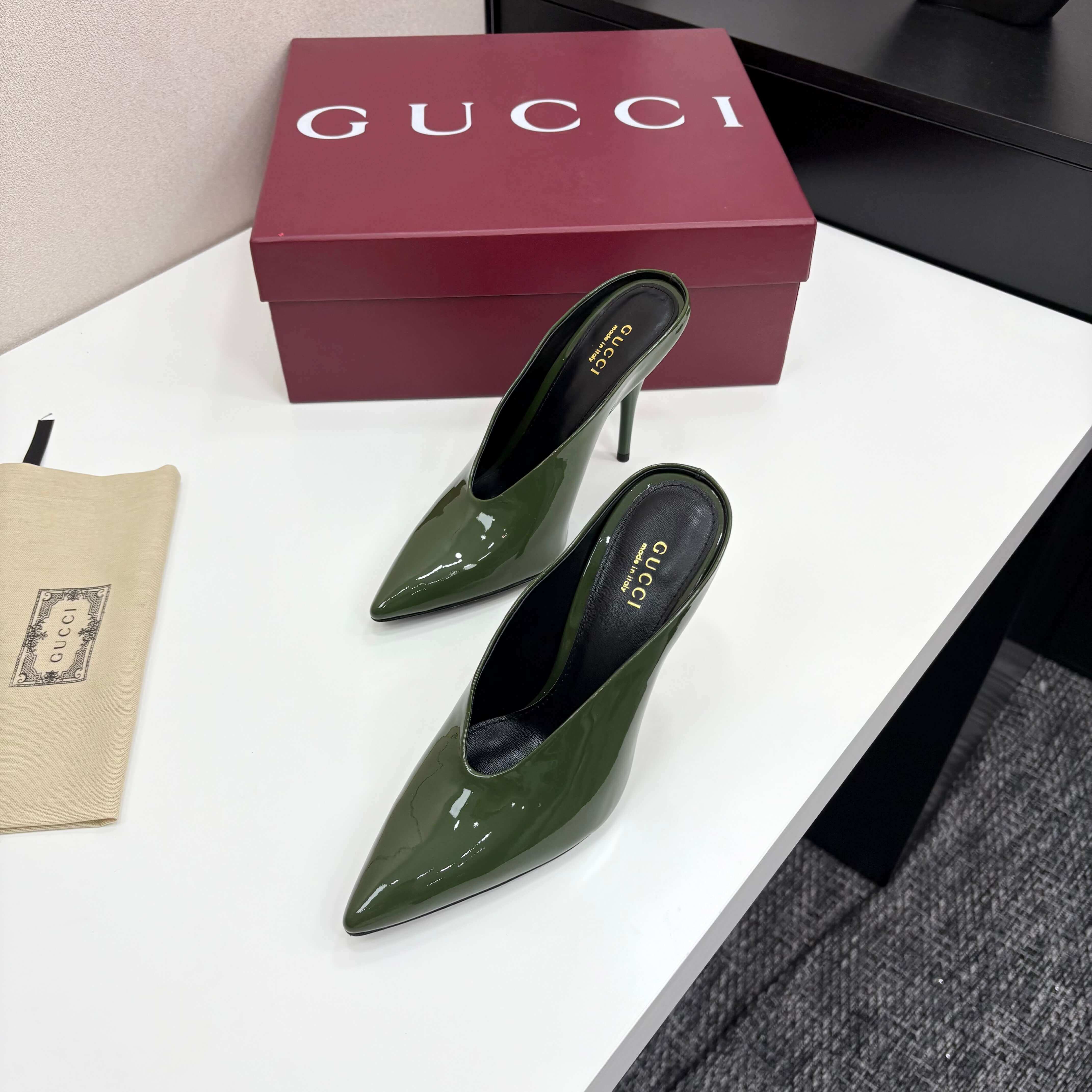 a pair of Gucci Women's Green Shiny Patent Leather Slingback Pumps with Pointed Toe and Thin Hee