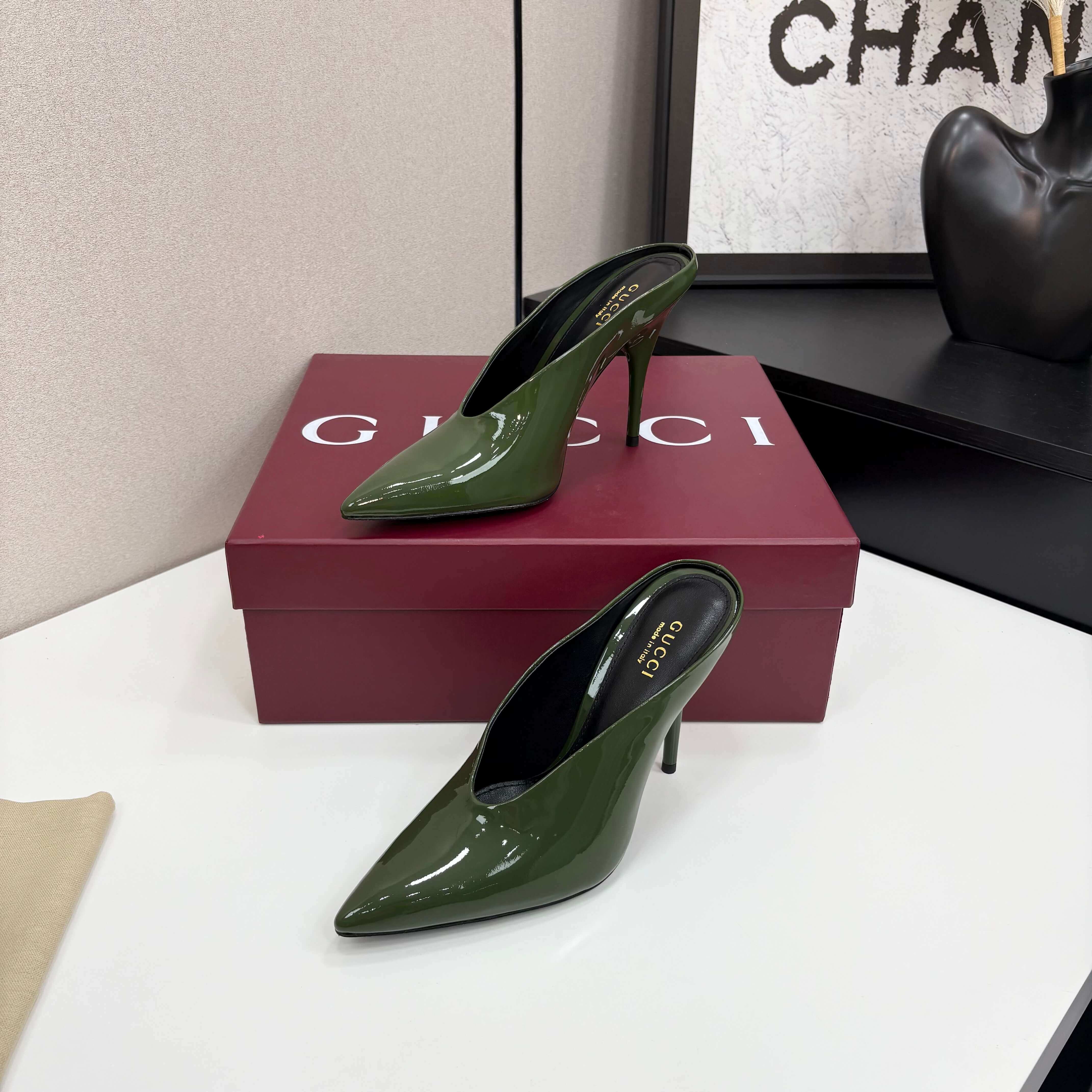 a pair of Gucci Women's Green Shiny Patent Leather Slingback Pumps with Pointed Toe and Thin Hee