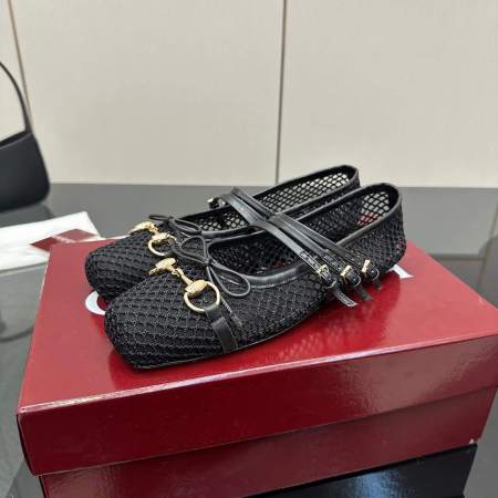 a pair of Gucci Women's Horsebit Ballet Flat - Black Mesh shoes on a red box