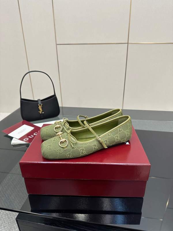a pair of Gucci Women's Horsebit Ballet Flat - Green Original GG Canvas on a box