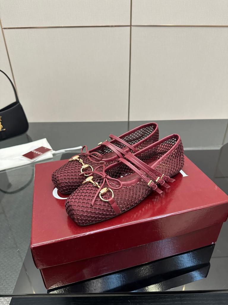 a pair of Gucci Women's Horsebit Ballet Flat - Rosso Ancora Red Mesh on a box