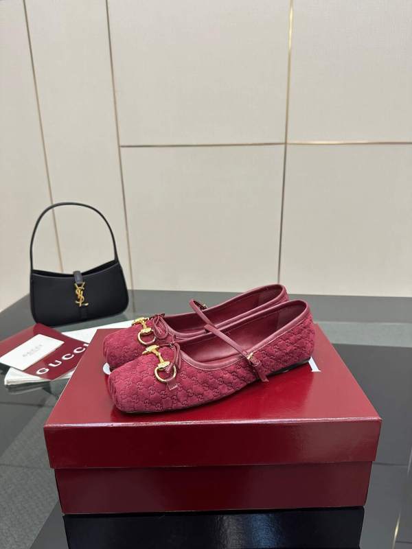 a pair of Gucci Women's Horsebit Ballet Flat - Rosso Ancora Red Original GG Canvas on a box