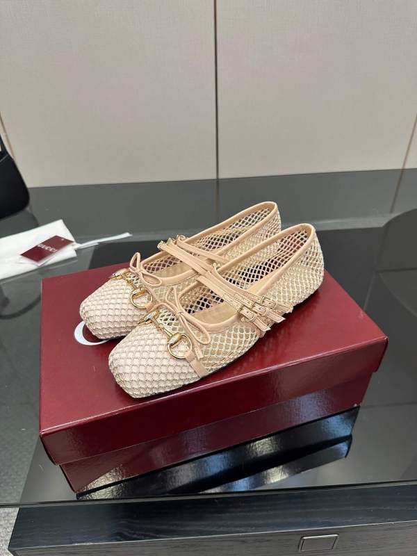 a pair of Gucci Women's Horsebit Ballet Flat in Beige Mesh. on a box