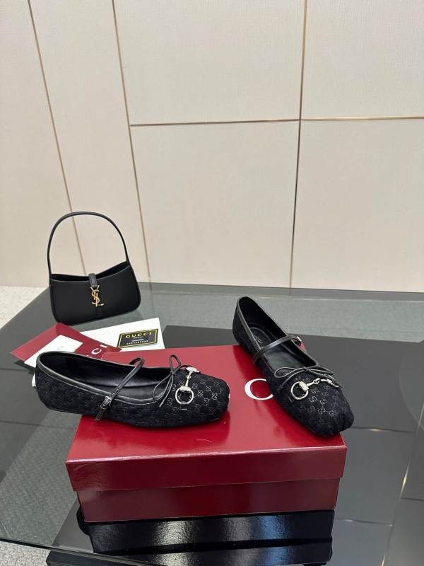 a pair of Gucci Women's Horsebit Ballet Flat in Black Original GG Canvas on a box