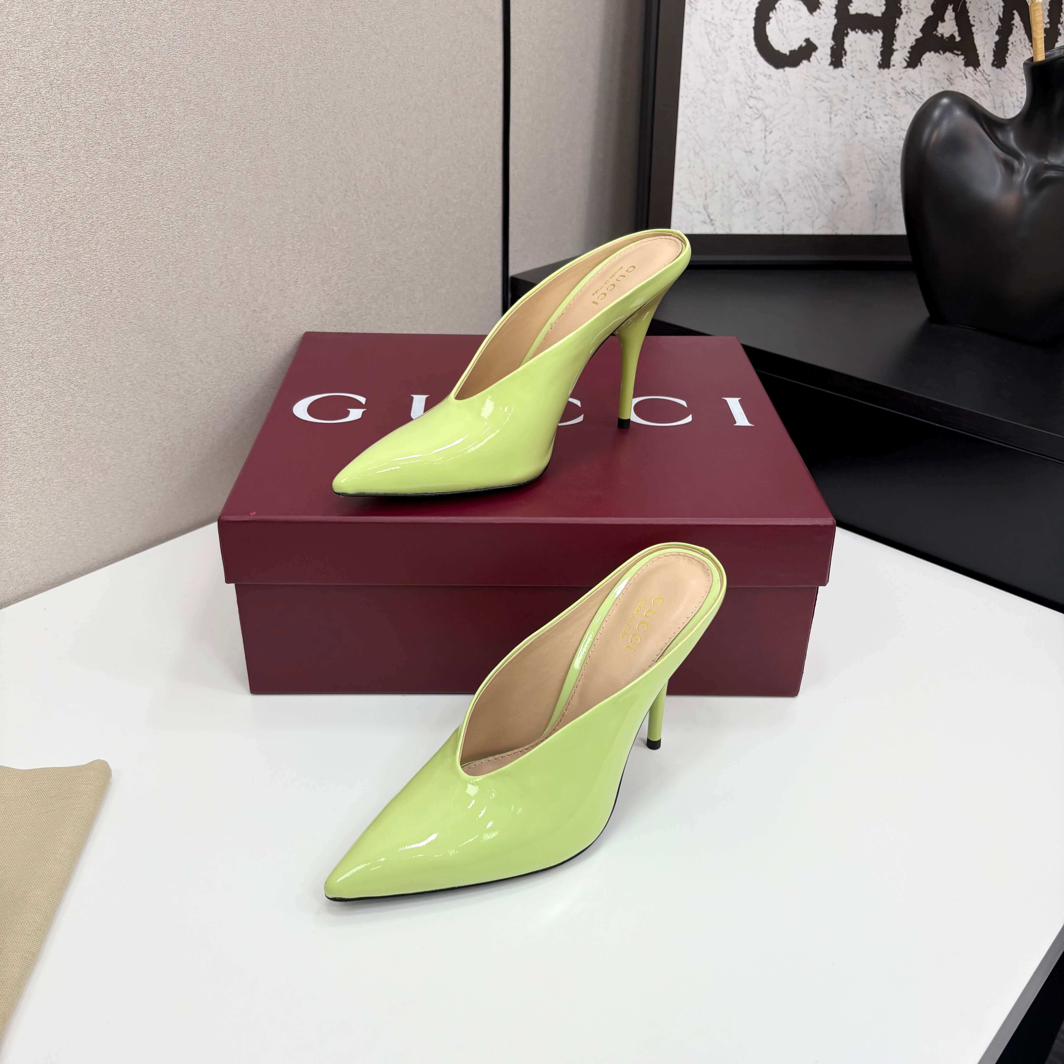 a pair of Gucci Women's Lime Green Shiny Patent Leather Pointed-Toe Stiletto Pumps on a red box