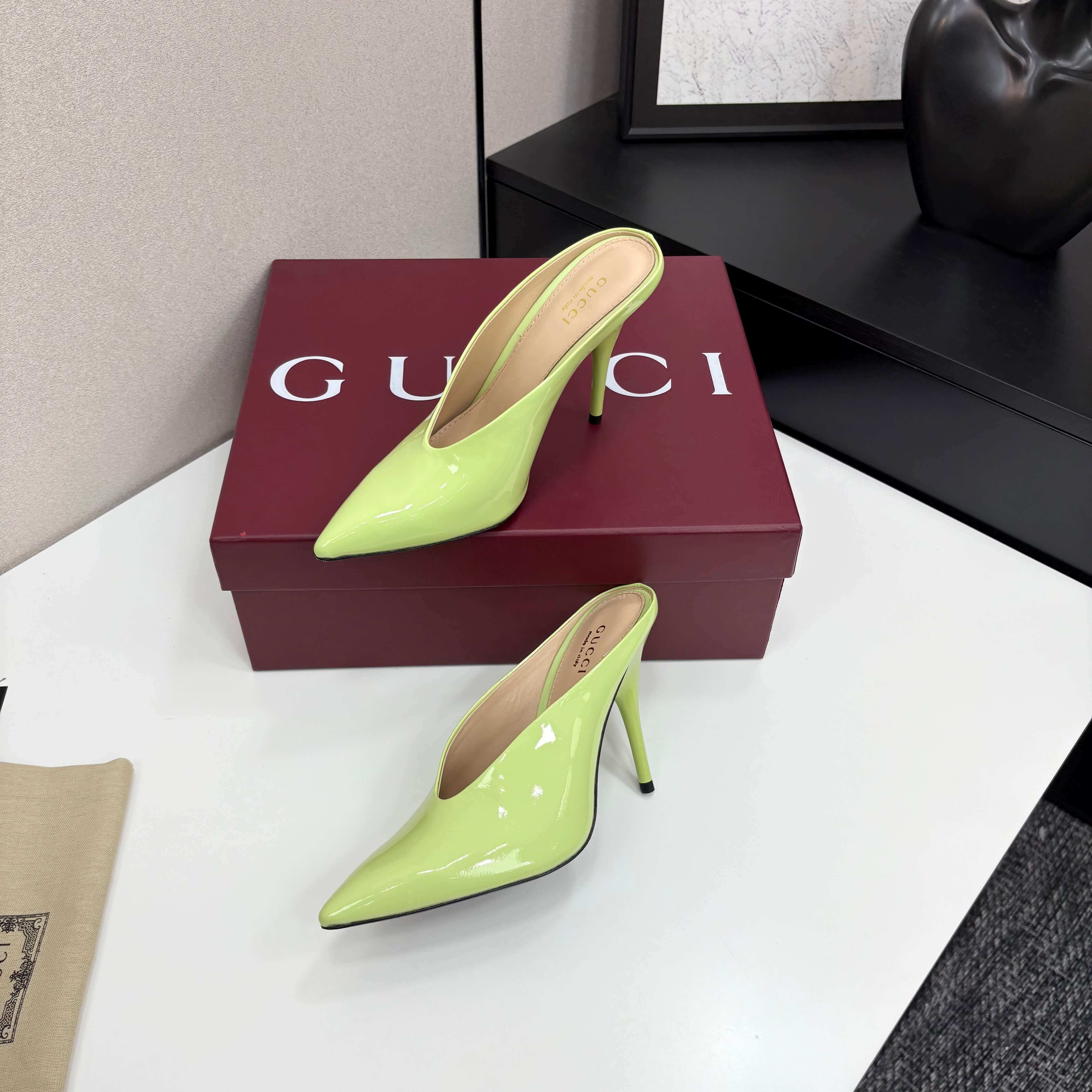 a pair of Gucci Women's Lime Green Shiny Patent Leather Pointed-Toe Stiletto Pumps on a red box