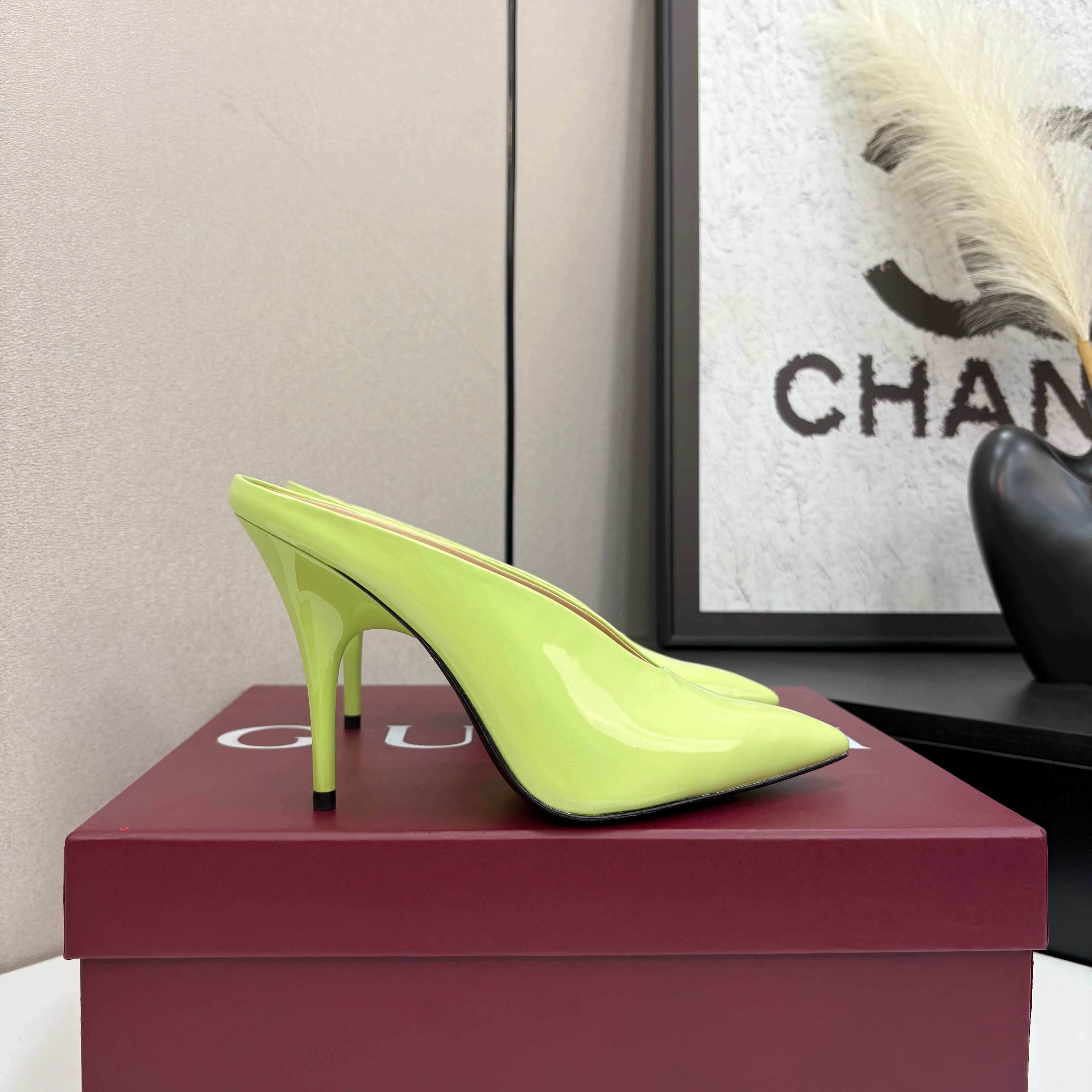 a pair of Gucci Women's Lime Green Shiny Patent Leather Pointed-Toe Stiletto Pumps on a red box