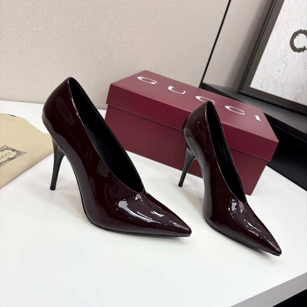 a pair of Gucci Women's Rosso Ancora Red Shiny Patent Leather Pointed-Toe Stiletto Pumps on a box