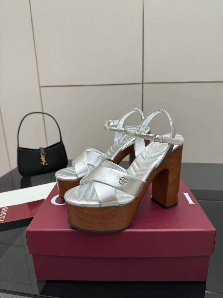 a pair of Gucci Womens platform sandal - Silver with Wooden Heel and Interlocking G Detail on a box