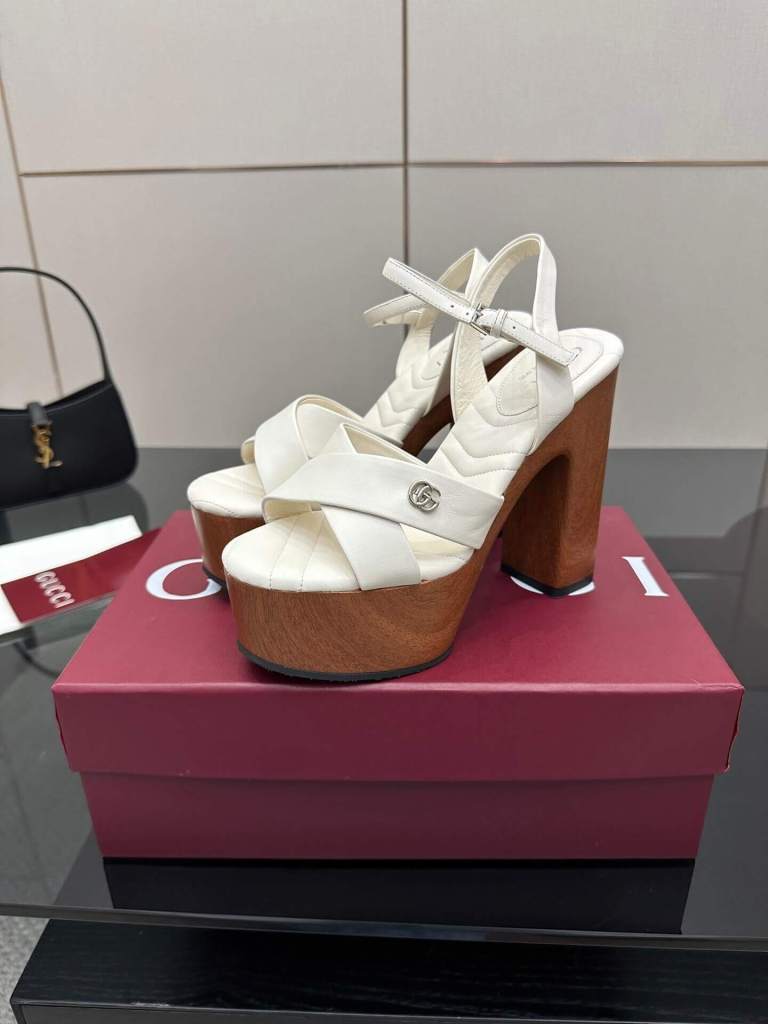 a pair of Gucci Womens platform sandal - White with Wooden Heel and Interlocking G Detail on a box
