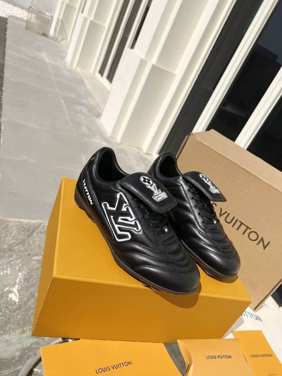 a pair of LV Footprint Soccer Sneakers – Bold Style, Game-Ready Vibe on a box