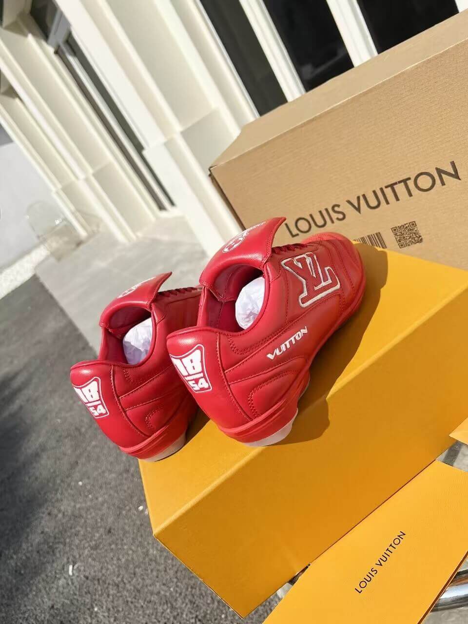 a pair of LV Footprint Soccer Sneakers – Bold Style, Game-Ready Vibe on a box