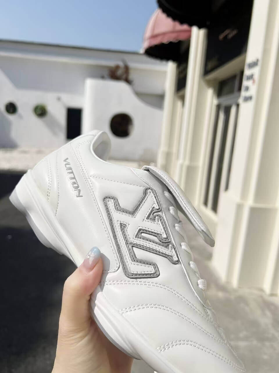 a pair of LV Footprint Soccer Sneakers – Bold Style, Game-Ready Vibe on a box