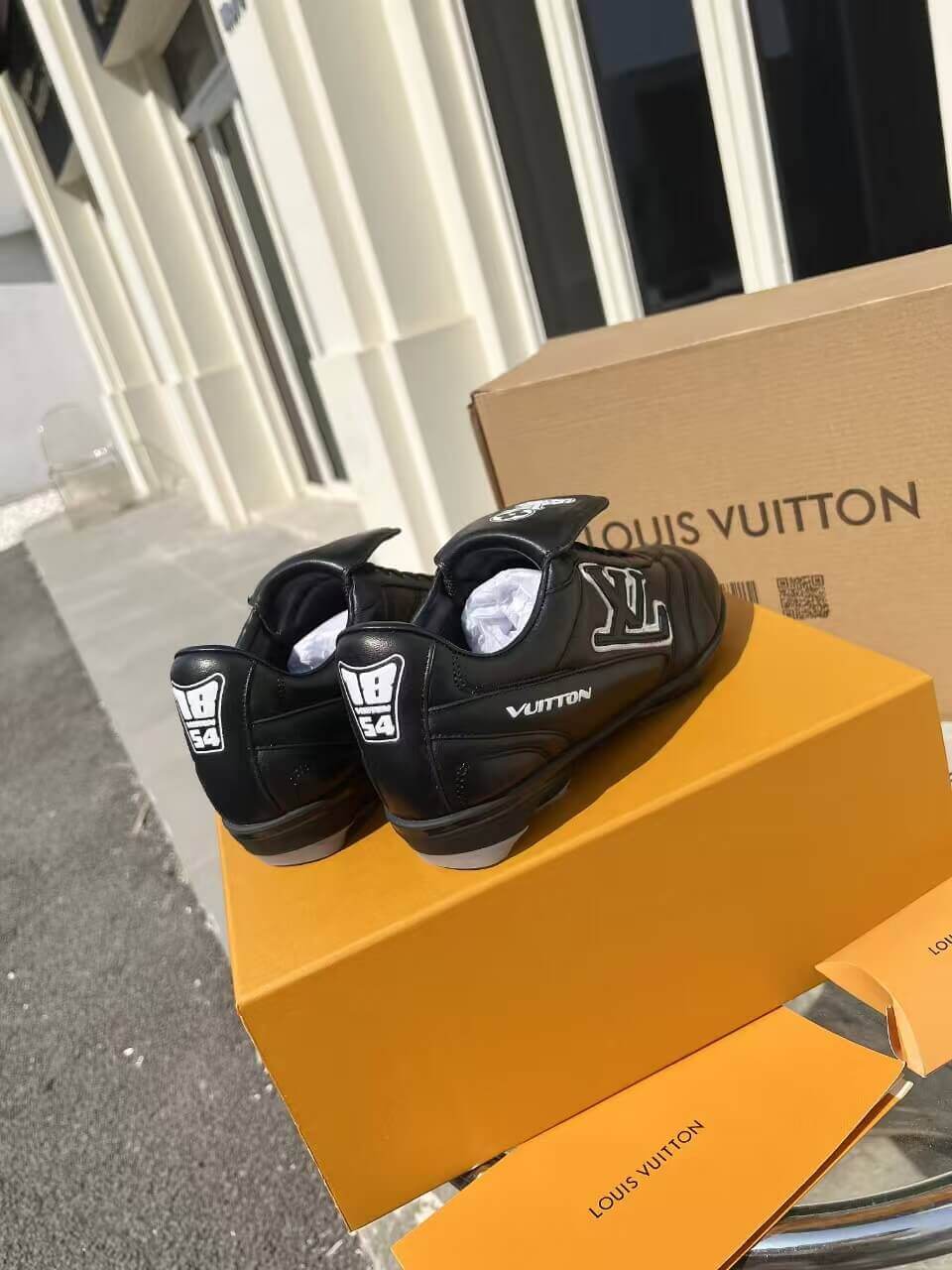 a pair of LV Footprint Soccer Sneakers – Bold Style, Game-Ready Vibe on a box