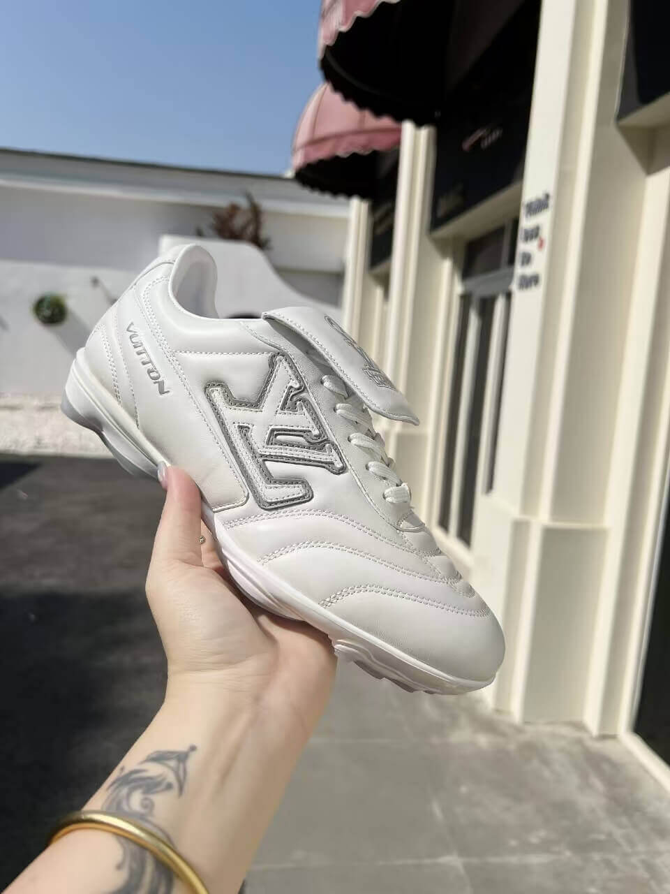 a pair of LV Footprint Soccer Sneakers – Bold Style, Game-Ready Vibe on a box