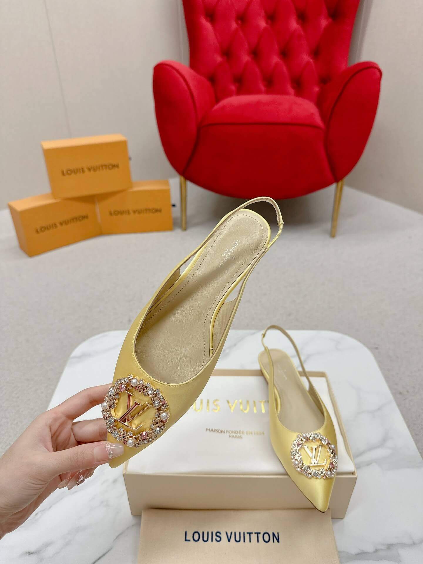 a pair of Louis Vuitton-Inspired Satin Slingback Flats – Yellow on a box