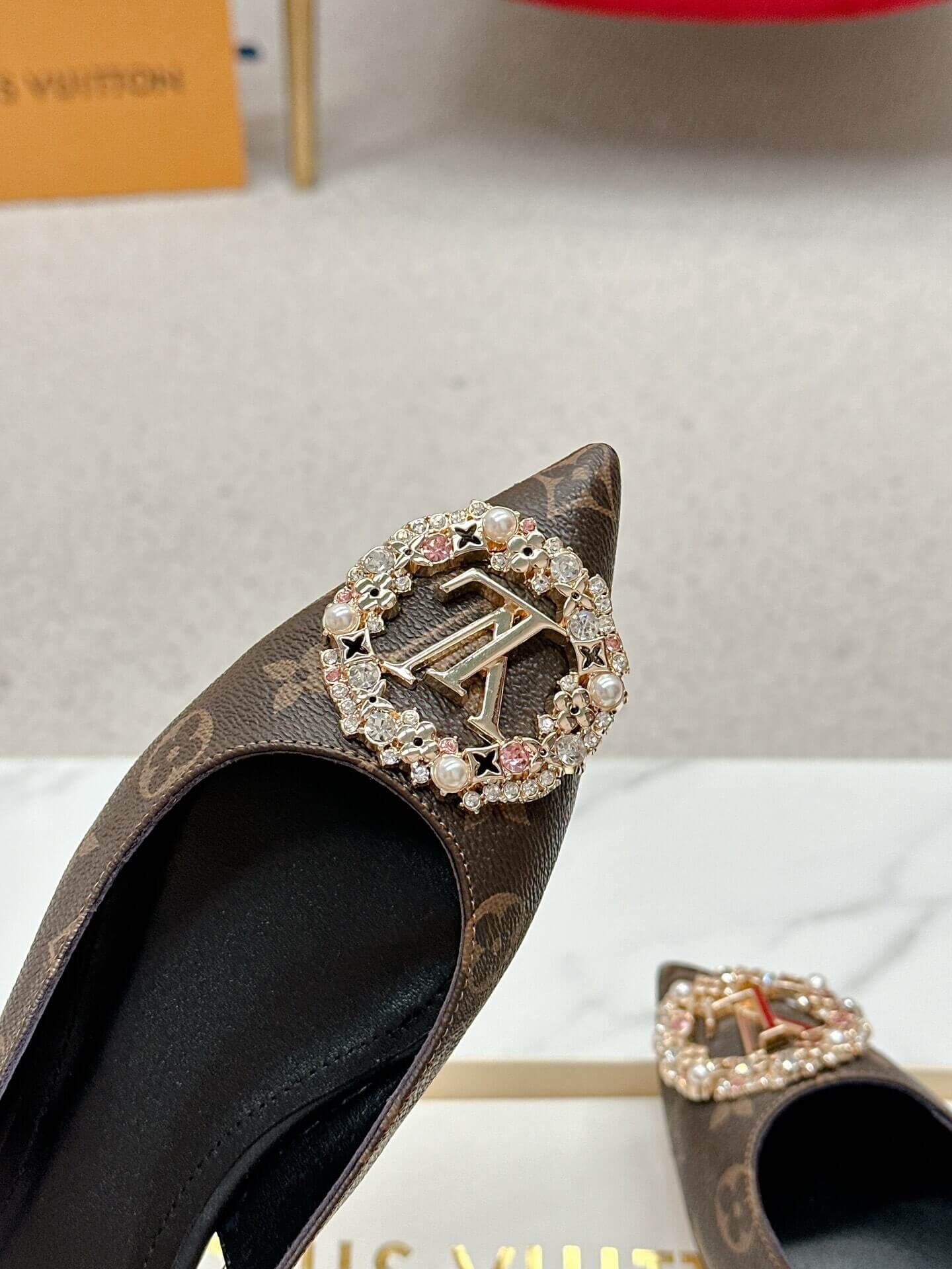 a pair of Louis Vuitton Classic Monogram Crystal Slingback Flats on a box
