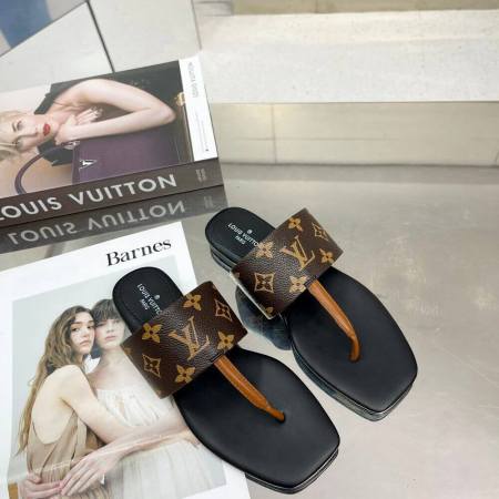 a pair of Louis Vuitton Drapy Flat Thong Sandal Black with Brown Monogram on a table