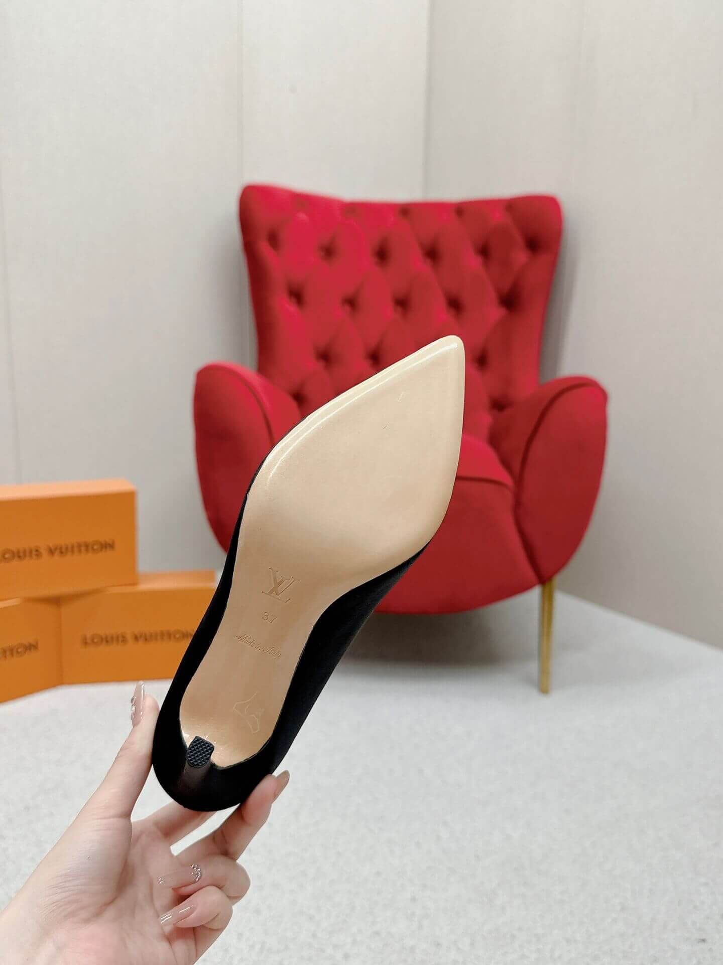 a pair of Louis Vuitton Elegant Black Satin Crystal Heels on a marble table