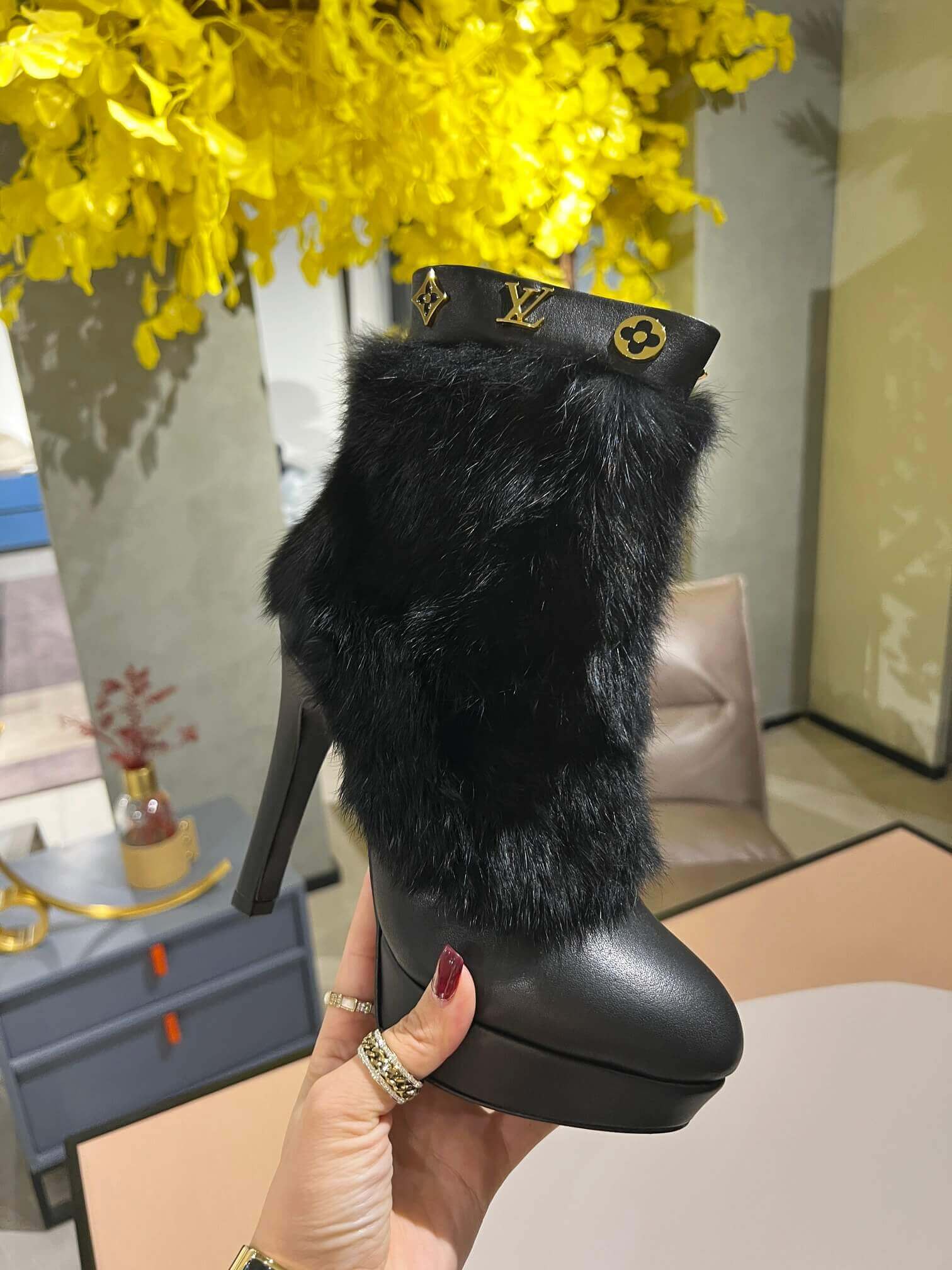a pair of Louis Vuitton Fluffy Fox Fur Ankle Boots (Black)