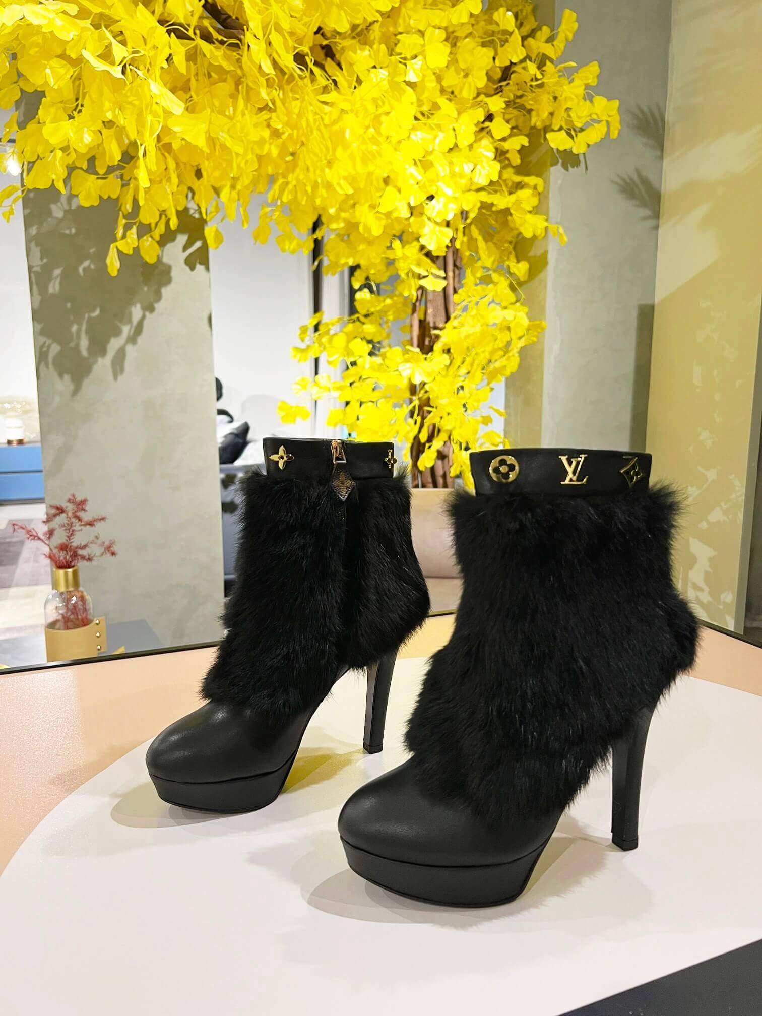 a pair of Louis Vuitton Fluffy Fox Fur Ankle Boots (Black)