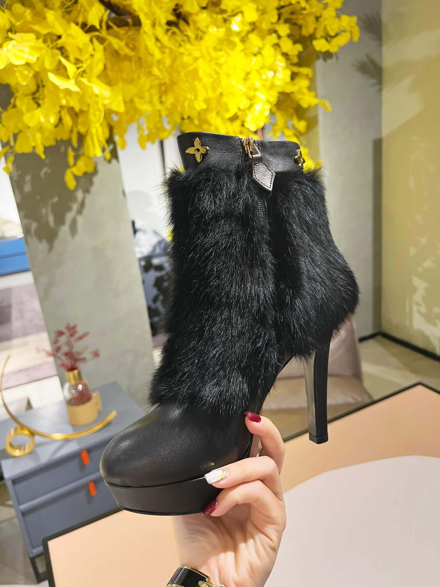 a pair of Louis Vuitton Fluffy Fox Fur Ankle Boots (Black)