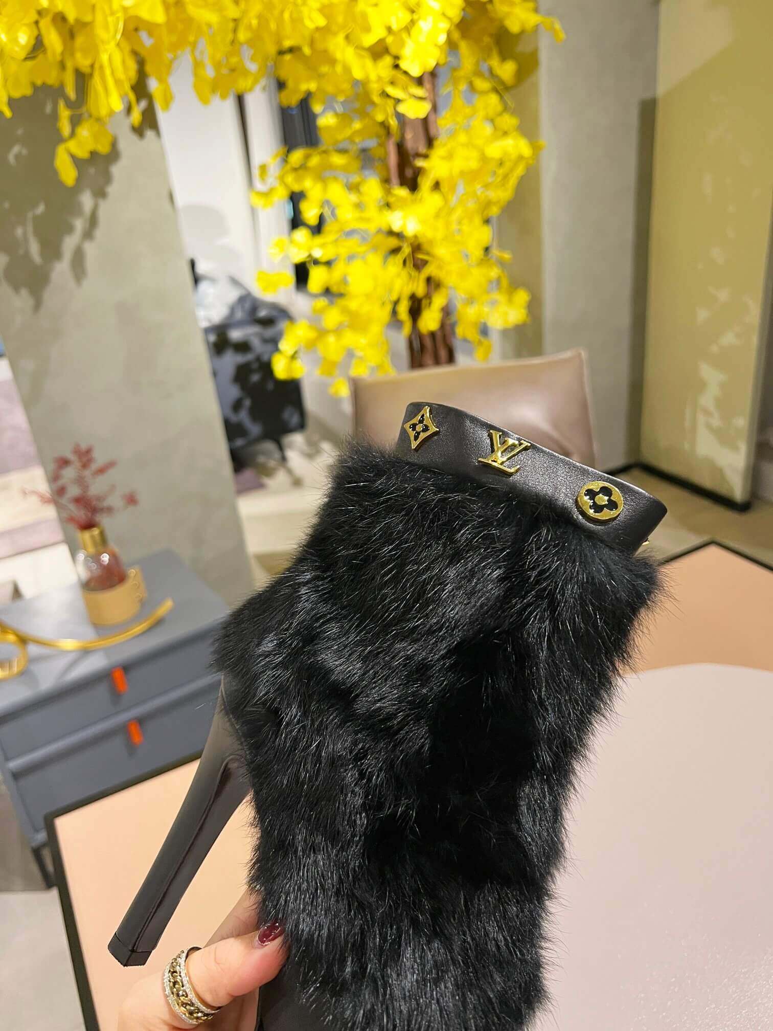 a pair of Louis Vuitton Fluffy Fox Fur Ankle Boots (Black)