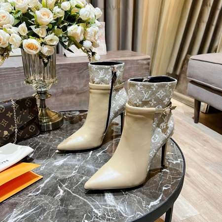 a pair of Louis Vuitton High-Heeled Ankle Boots IN Beige Monogram on a table
