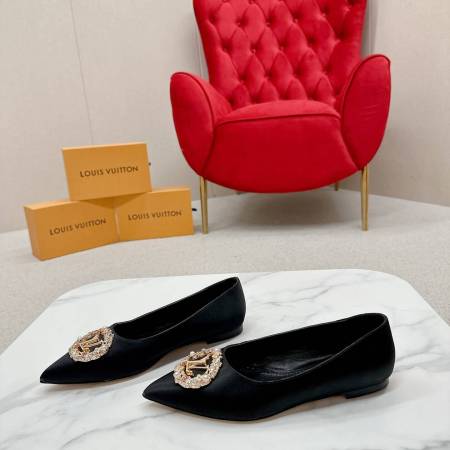 a pair of Louis Vuitton Inspired Crystal Embellished Satin Flats in Black on a marble table chair