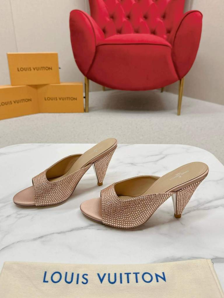 a pair of Louis Vuitton Inspired Rose Gold Super Mule Heels on a marble table