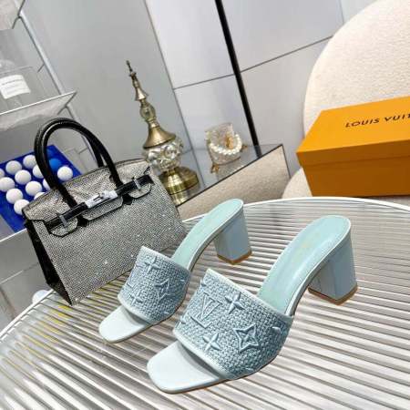 a pair of Louis Vuitton LV Mare Mule in a calming light blue on a glass table